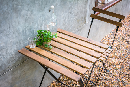 Outdoor table and chair on concrete background at coffee shopの写真素材