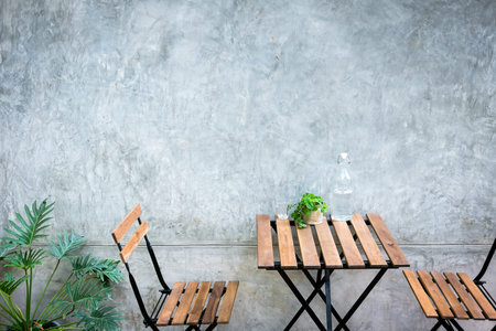 Outdoor table and chair on concrete background at coffee shop