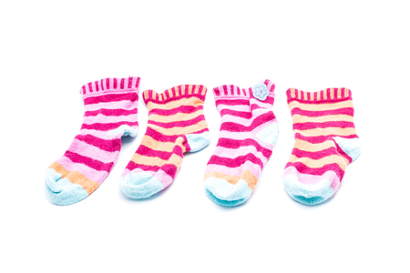 Small colorful socks striped for children on a white background, isolated objects.の写真素材
