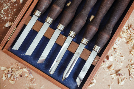 Set of carpenter tools on the wood table background. Top view