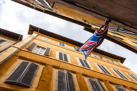 Narrow street and Banner of the contrads in Siena. Tuscany, Italyの写真素材