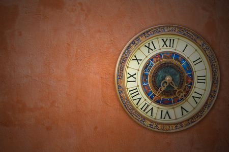 Retro vintage clock on simple Orange wall backgroundの写真素材