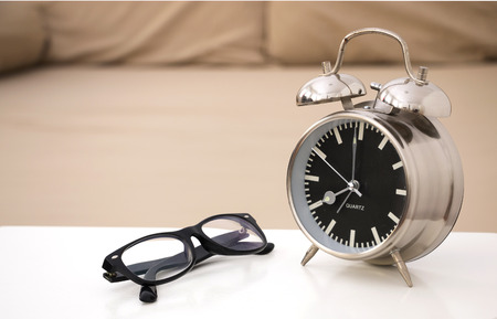 Alarm clock and glassesの写真素材