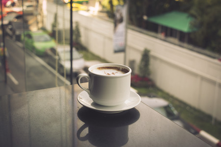 Coffee cup in coffee shop - vintage style effect pictureの写真素材
