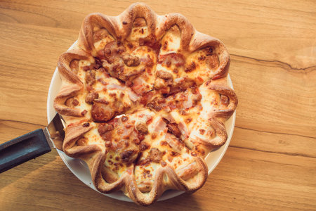 Delicious italian pizza served on wooden tableの写真素材