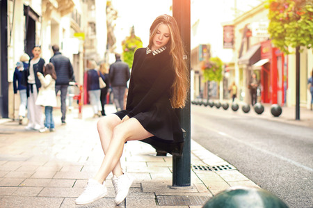 Close-up Fashion woman portrait of young pretty trendy caucasian girl posing at the city in Europe,summer street fashion with lovely sun backlight backgroundの写真素材