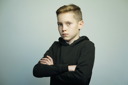 Portrait of a handsome teenage bad boy with stylish haircut, softbox lighting studio shot.の写真素材
