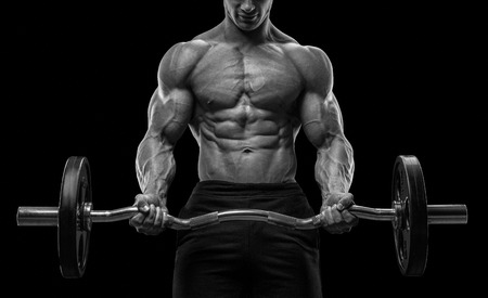 Closeup portrait of a muscular man workout with barbell at gym. Brutal bodybuilder athletic man with six pack perfect abs shoulders biceps triceps and chest. Deadlift barbells workout. Black and white photoの写真素材
