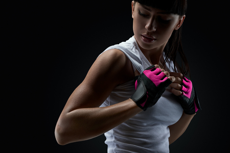Ð¡lose up portrait of fitness athletic young woman in sports clothing showing her well trained bodyの写真素材