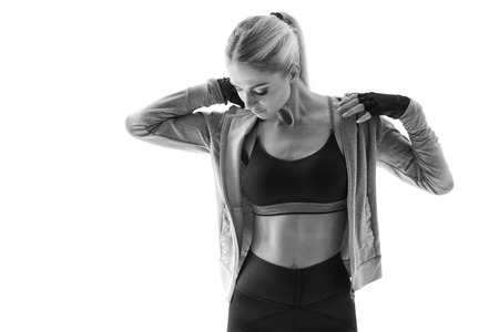 Black and white close-up shot of fit young female fitness model taking a break after workout Fitness woman in sportswear bra taking a break Attractive woman athlete bodybuilder posingの写真素材