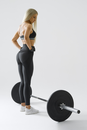 Image of woman with barbell Female athlete before exercising with heavy weights at gym. Female performing deadlift exercise with weight barの写真素材