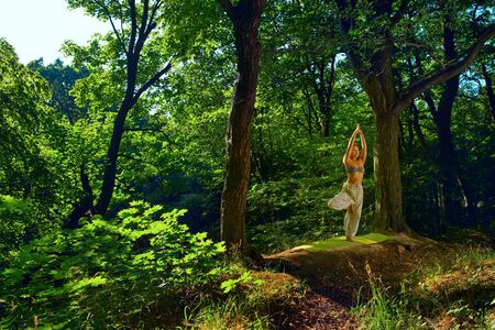 Spiritual travel relaxation lifestyle concept Harmony with nature Healthy fitness background Asana yoga pose. Beautiful portrait of asian female yoga trainer. Outdoors lifestyle summer relaxationの写真素材