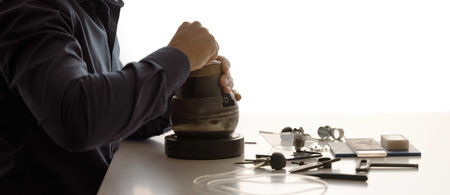 Engraver At The Desk With Professional Tools On White Desk. Professional engraver equipment for...