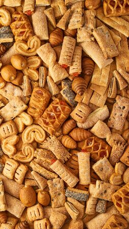 Top view of a variety of cookies Texture background of the pastry in the studio Backgrounds and textures: group of various cookies An abundance concept of sweet and unhealthy carbohydrate-rich foods.の写真素材