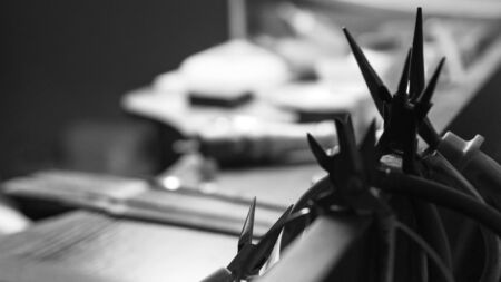 Needle-nose pliers silhouette black and white photo. Artisan workspace background concept with free copy space A lot of pliers.の写真素材