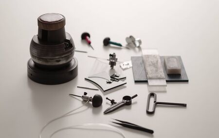 Various Engraver Tools On White Desk. Professional engraver equipment for jewelleries manufacturing Craftsman Engraver Jewellers Workplace Conceptの写真素材