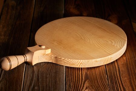 Background with cutting board on wooden table Space of wooden top Wooden background with wooden table and round cutting boardの写真素材