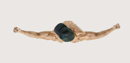 Top view shot of healthy muscular young man with black baseball cap. Shirtless male bodybuilder with muscular build rising muscular power hands. White backround. Image with clipping pathの写真素材
