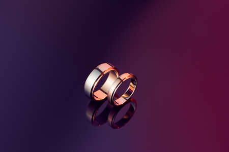 Two wedding rings isolated on polished coloredの写真素材