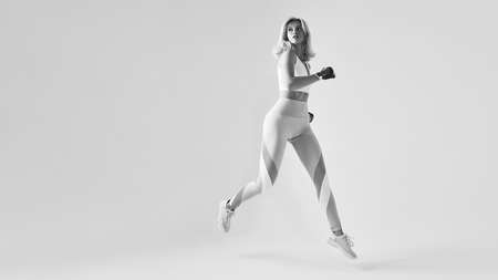 Motivated happy fit sporty woman runningの写真素材