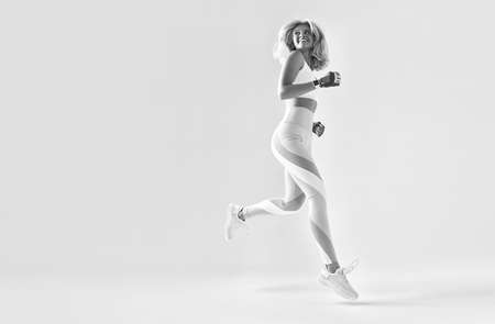 Caucasian female in sportswear runningの写真素材