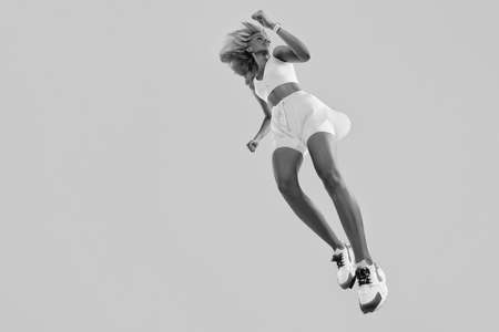 Woman in fitness wear jumpingの写真素材