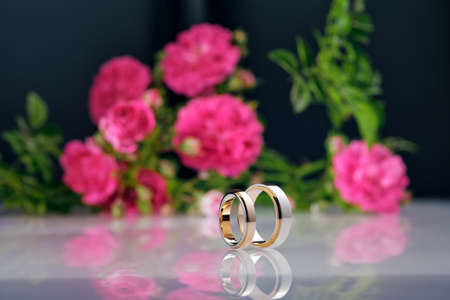 Two tone rose gold and white gold wedding rings. Mens and womens wedding rings close-up,の写真素材