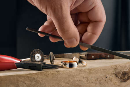 Jeweller craftsman and manually polished two tone rose gold and white gold wedding rings.の写真素材