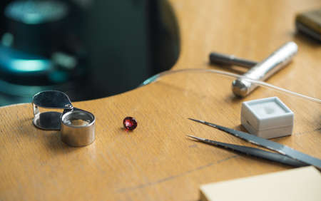 Jeweler tweezers, Magnifier, Ruby gemstone.の写真素材