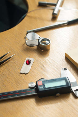 Jeweler tweezers, Magnifier, Ruby gemstone.の写真素材