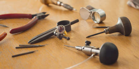 Various jeweler tools on the wooden tableの写真素材