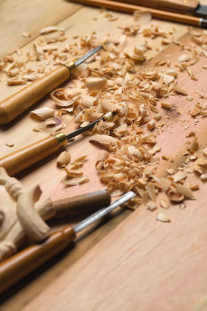 Woodworkers desk. Woodworking tools and shavings on a wooden table. Wood carving process.の写真素材