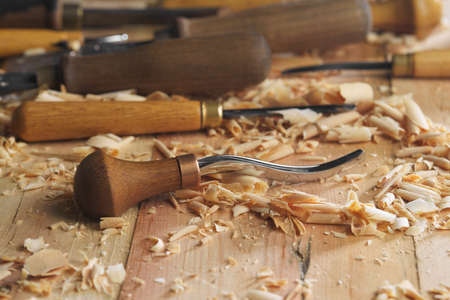 Woodworking tools. Carving wood with chisel. Carpenters hands use chieselの写真素材