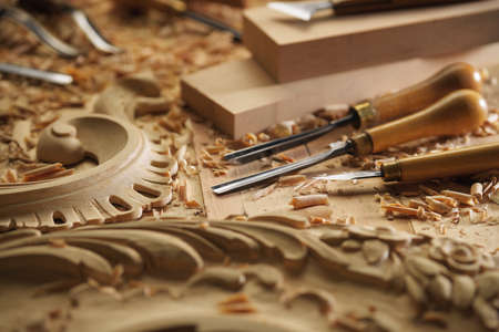 Woodworking tools. Carving wood with chisel. Carpenters hands use chieselの写真素材