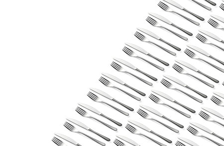 Knife and fork flat lay pattern on pastel white background. Many metallic forks, and knives top view concept. Background for menu. Restaurant backdrop. Creative top view pattern. Copy free space.の写真素材