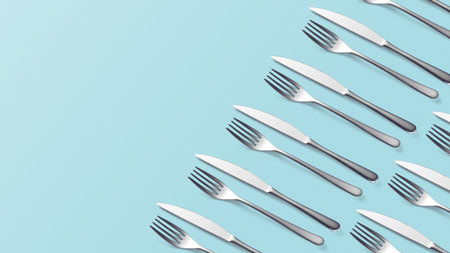 Set Cutlery Pattern of Fork and knife on pastel blue top view Stylish classy elegant metallic eating knife and fork cutlery for dining kitchen utensilsの写真素材
