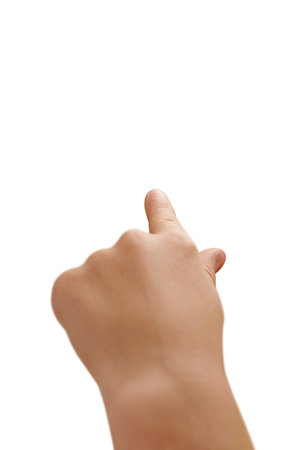 Confident left-handed child points upwards with their index finger, symbolizing hope, inspiration, and leadership.の写真素材