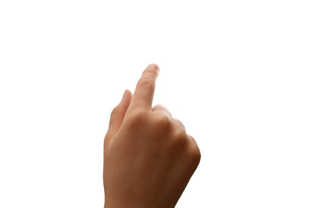 Right hand of young girl or boy pointing to something. Isolated photo. Concept for educational and parenting campaigns. Copy free space.の写真素材