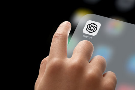 ChatGPT Application Icon on display. Index finger of childs hand pointing or starting an application with AI chatbot by OpenAI on display screen. Istanbul, Turkey, May 05, 2023.のeditorial素材