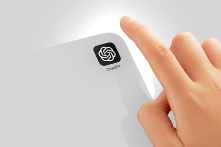 Istanbul, Turkey - May 05, 2023: ChatGPT chat bot application icon on screen and index finger of the childs hand start application. AI or artificial intelligence chatbot developed by OpenAI.のeditorial素材