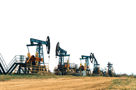 Oil Pump Jacks. Country road and Oil pumps, nodding donkey or pump jack and rig.の写真素材