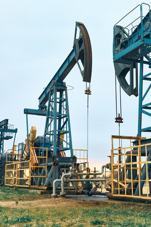Prairie Oil Pump Jacks. Crude oil is a major economic driver. Themes in the image include geology, engineering, pump, rig, well, gas, coal, methane, natural gas, oil, natural resources, and energy.の写真素材
