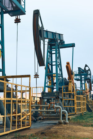 Prairie Oil Pump Jacks. One pump jack producing oil. Crude oil is a major economic driver.の写真素材