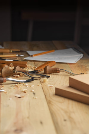 Woodwork. Chisels laid in wooden shavings on desk. Carving tools lying in the shavings carving...