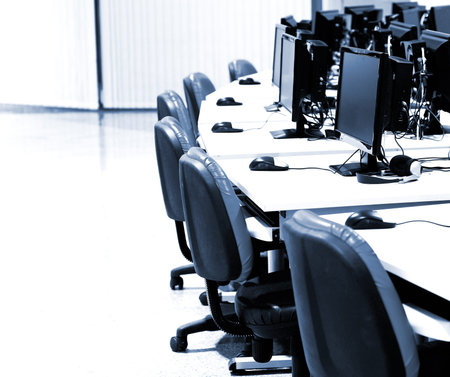 modern computer room with computers in row