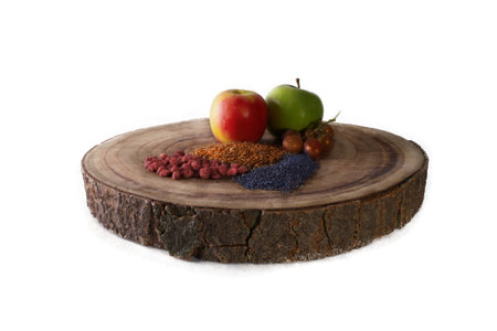 Fruit and seeds on a wooden block, on a white backgroundの写真素材