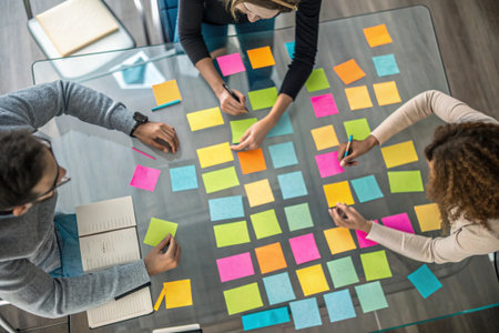 High angle view of business people brainstorming over sticky notes in officeの素材