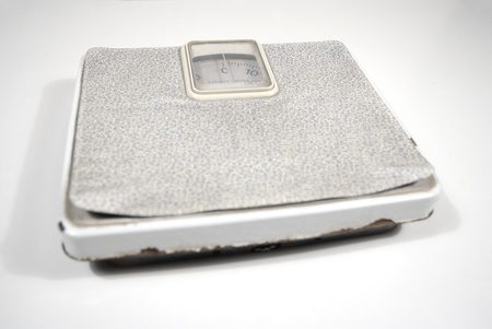 aged domestic scale on white backgroundの写真素材