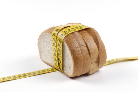 How the daily food help us With The diet, a large amount of bread rounded by one measuring tapeの写真素材