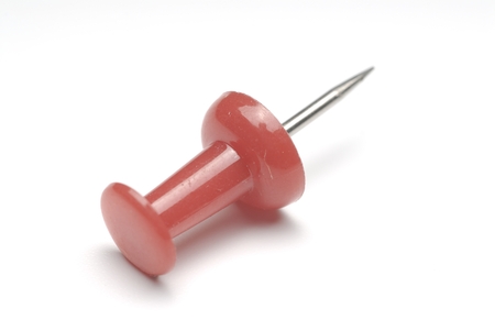 One red plastic marker on white backgroundの写真素材